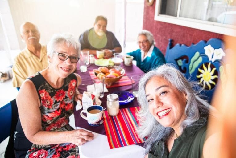 A group of older friends take a selfie together