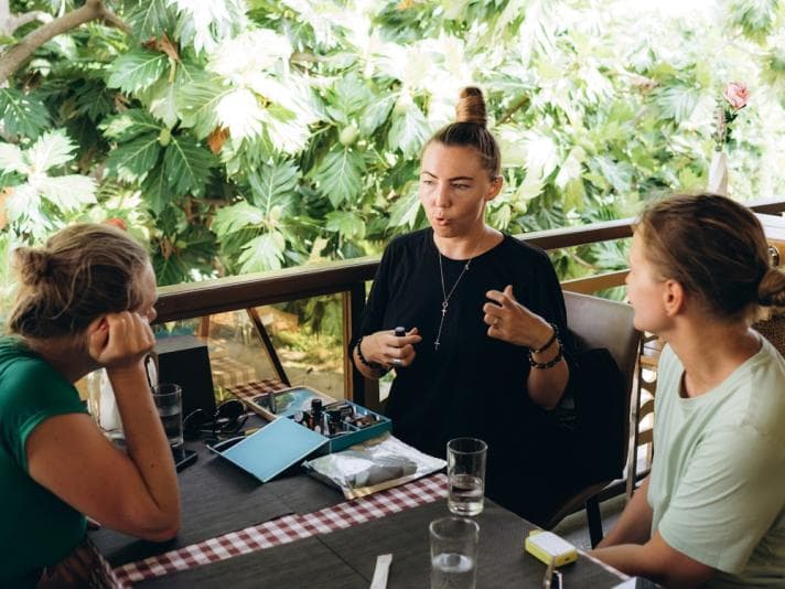 Three women talking at a cafe