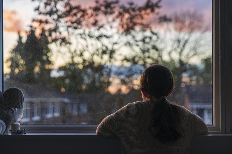 An upset child looking out of the window