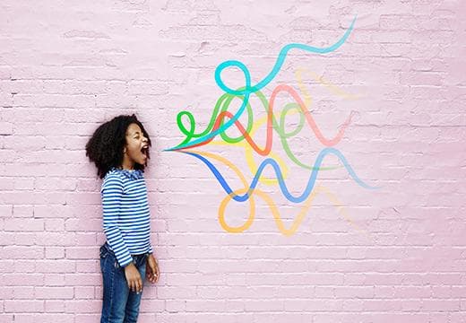 Child shouting against colours on wall