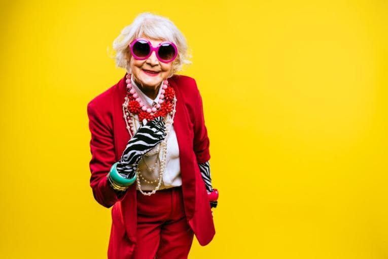 A brightly, snazzily dressed older person