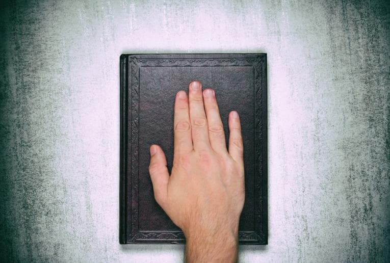 Hand on religious book